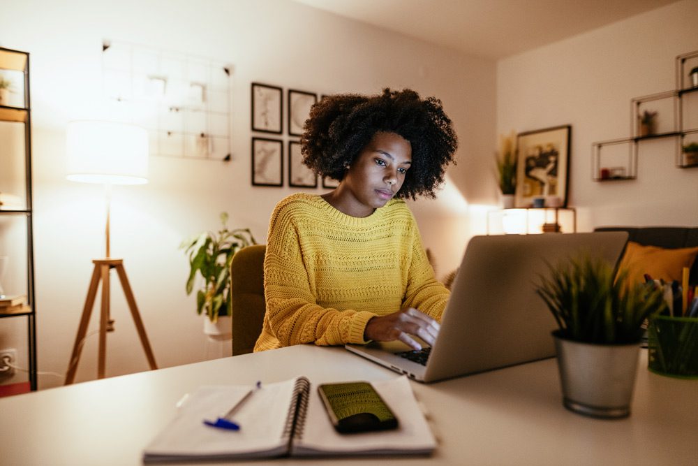 Young African American woman at home studying