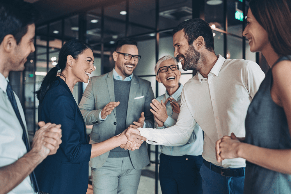 business people shake hands while smiling
